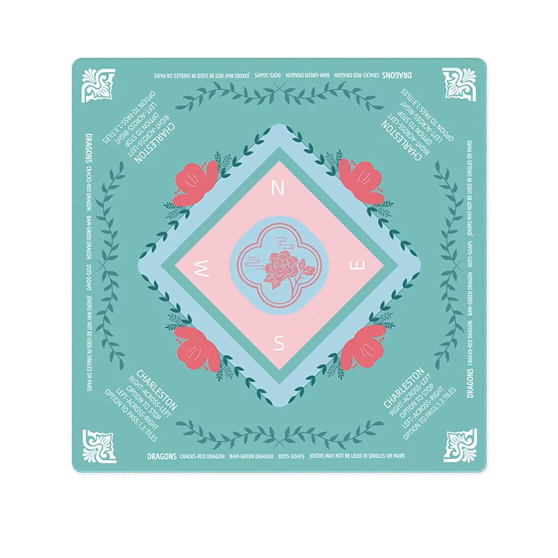 Decorative mahjong mat with floral design and compass rose on a teal background