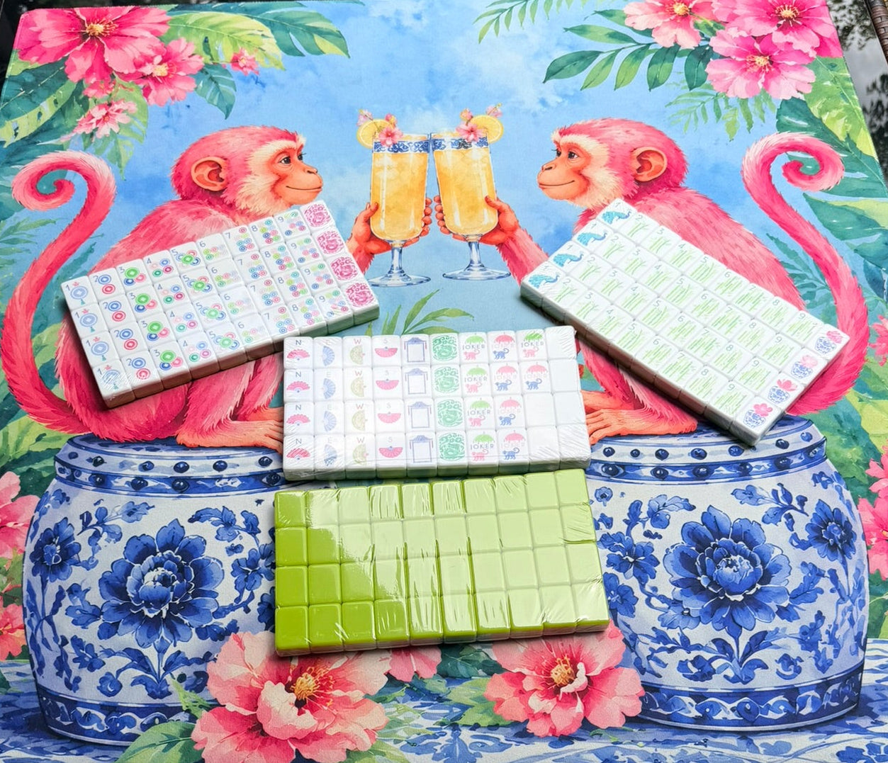 pink floral monkey mahjong mat with cypress green tiles on top of the mat