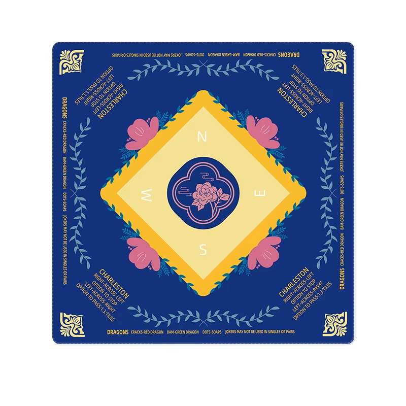 Decorative mahjong mat with floral design and compass rose on a blue background
