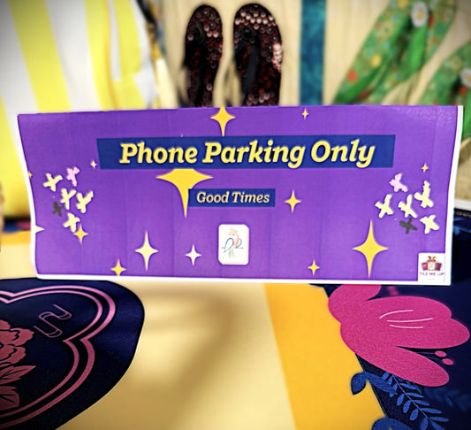 A styled phone parking zone tray set up beside a Mahjong table for a modern game night