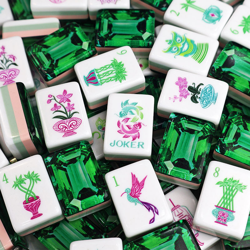 Collection of colorful mahjong tiles with various designs on a green and white background.