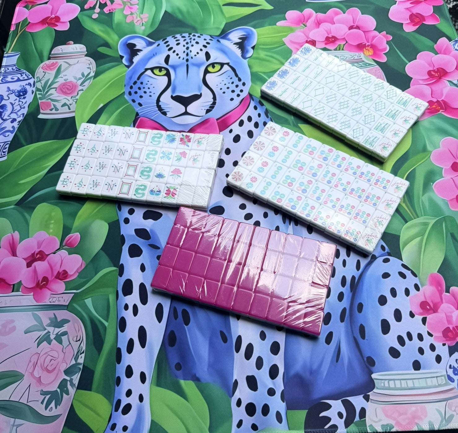 Leopard character mahjong mat  on a  table with pink carnival bloom mahjong tiles displayed on top