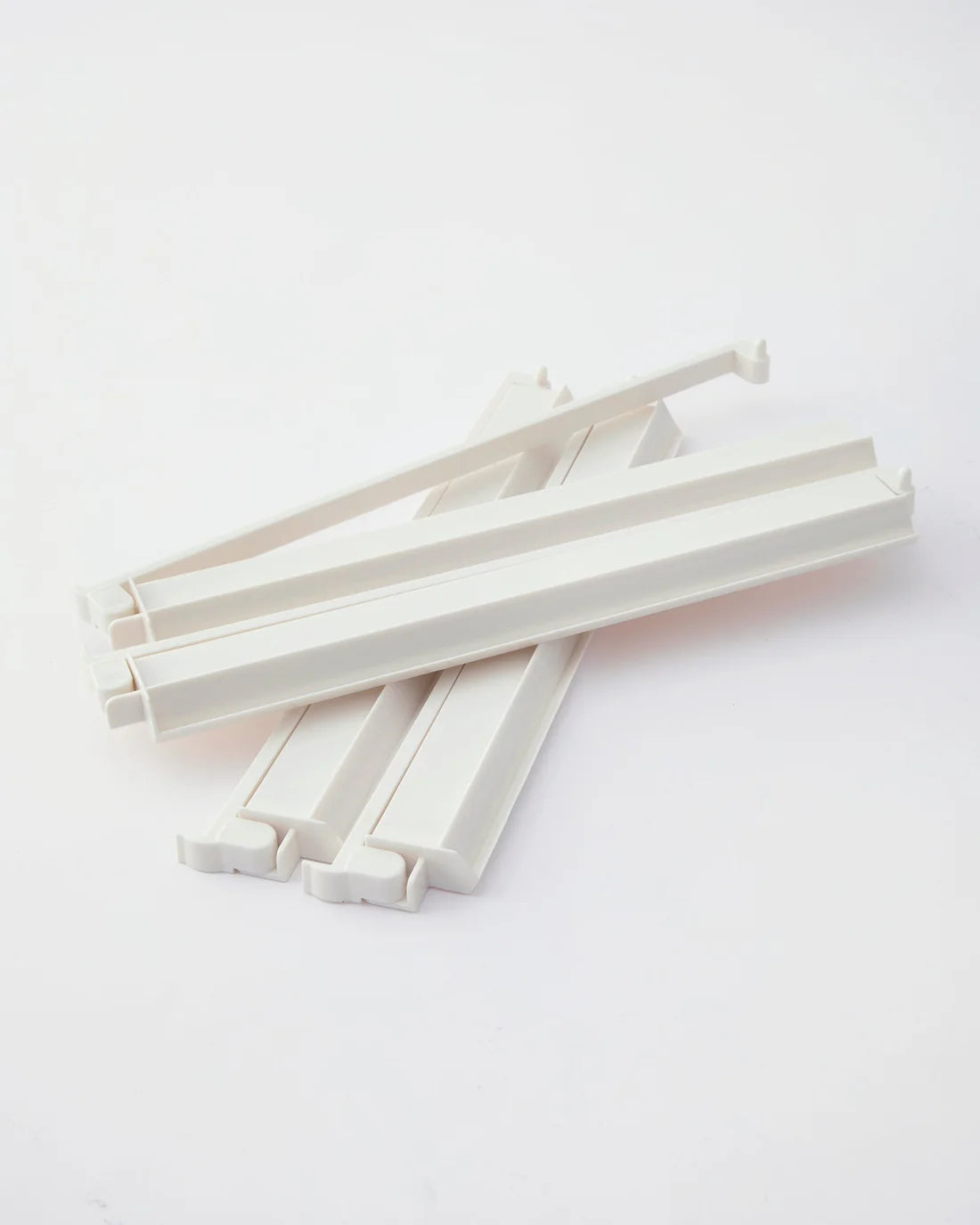 a set of white acrylic mahjong racks with pushers