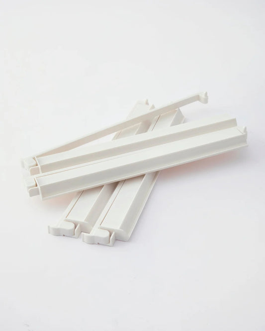 a set of white acrylic mahjong racks with pushers